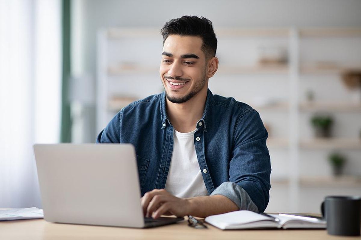 Man on laptop condenses his resume