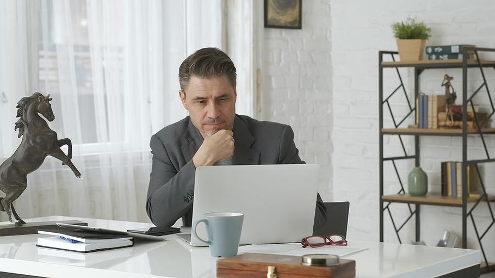 Man on laptop connects with new people on LinkedIn