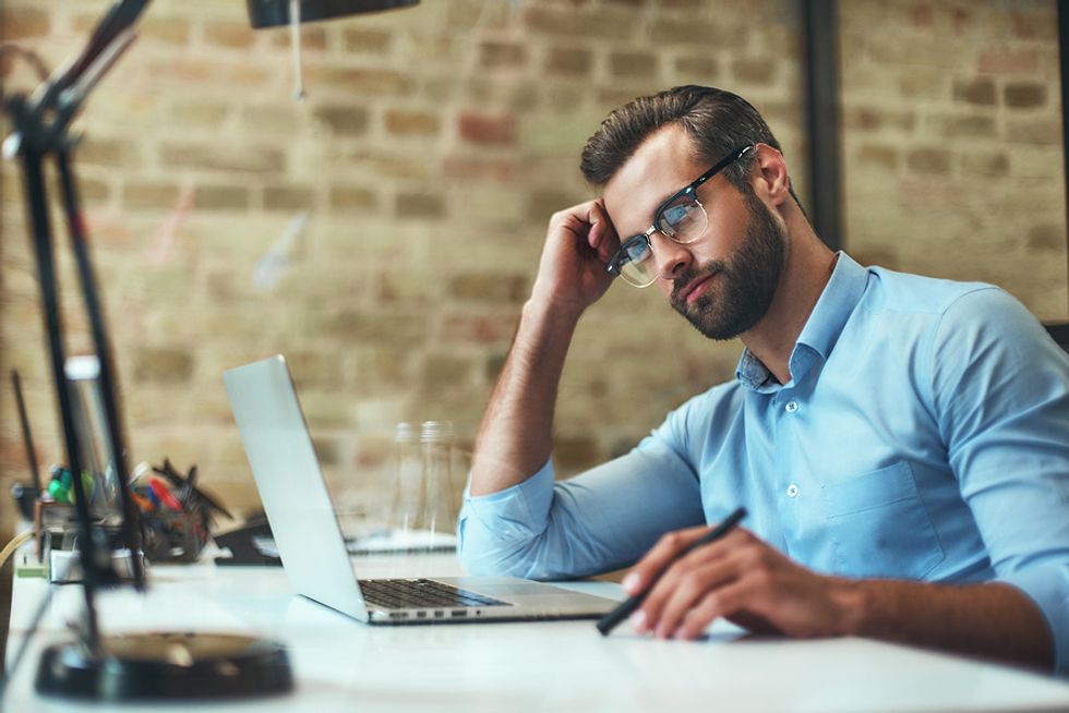 Man on laptop considering a job offer