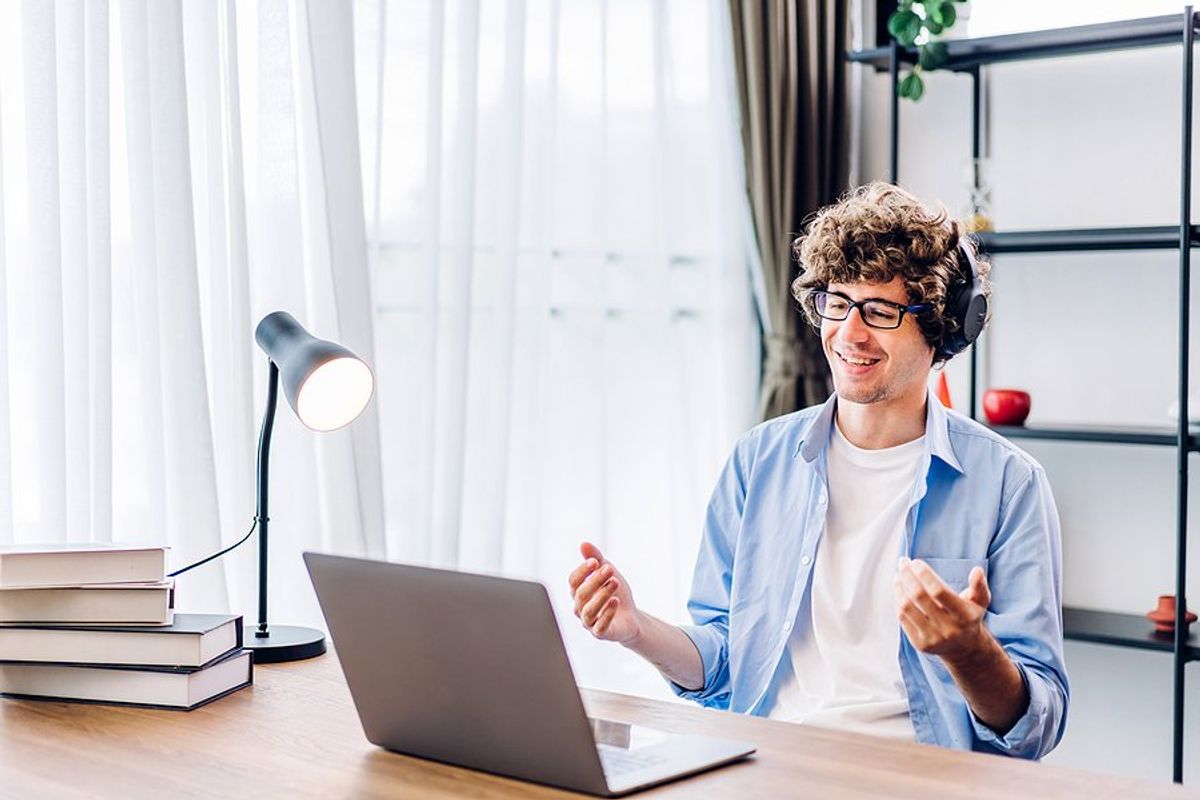 Man on laptop develops his skills on the job