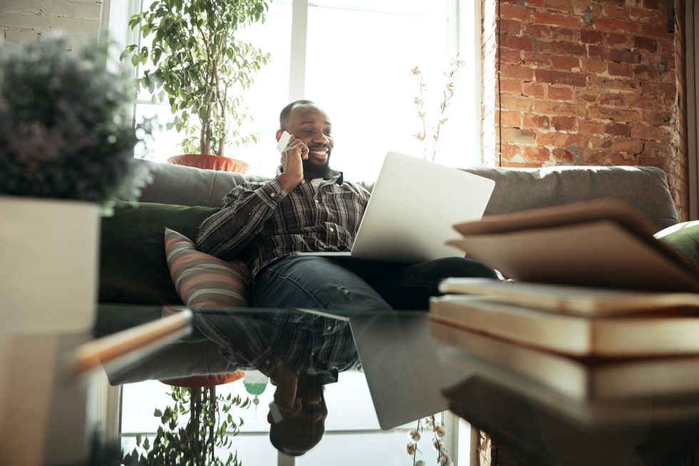 Man on laptop does freelance work during the summer