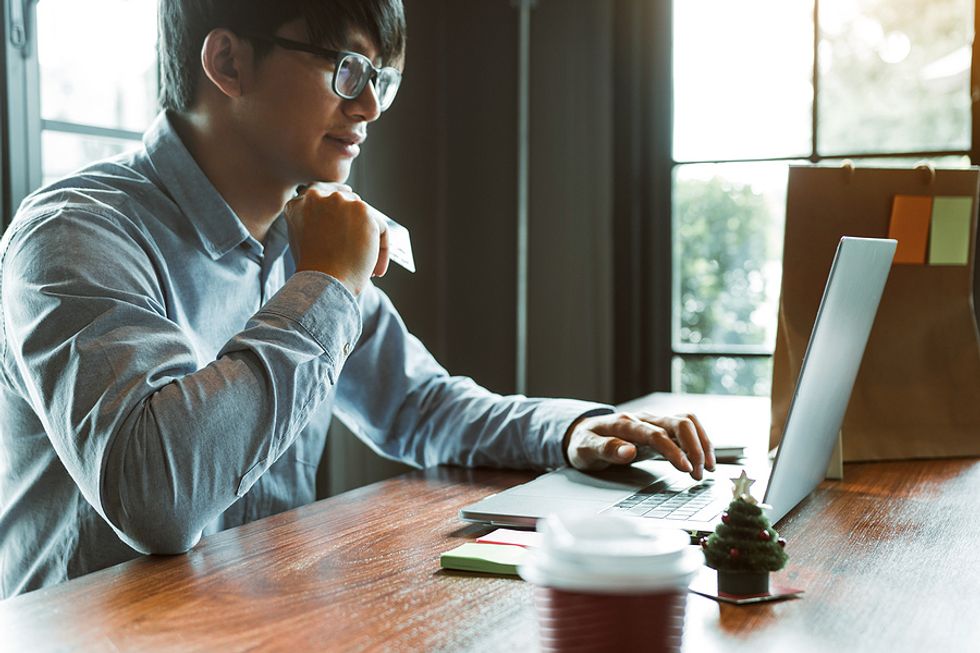 Man on laptop follows directions while writing a cover letter