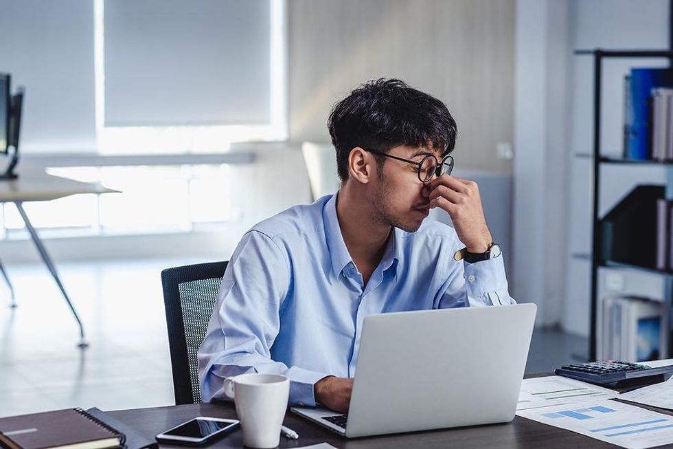 Man on laptop frustrated about confusing resume words