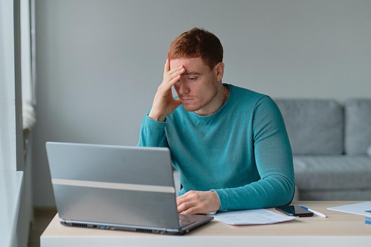 Man on laptop frustrated that his resume isn't working in his job search