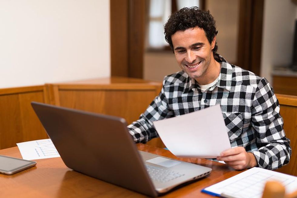 Man on laptop joins groups on LinkedIn
