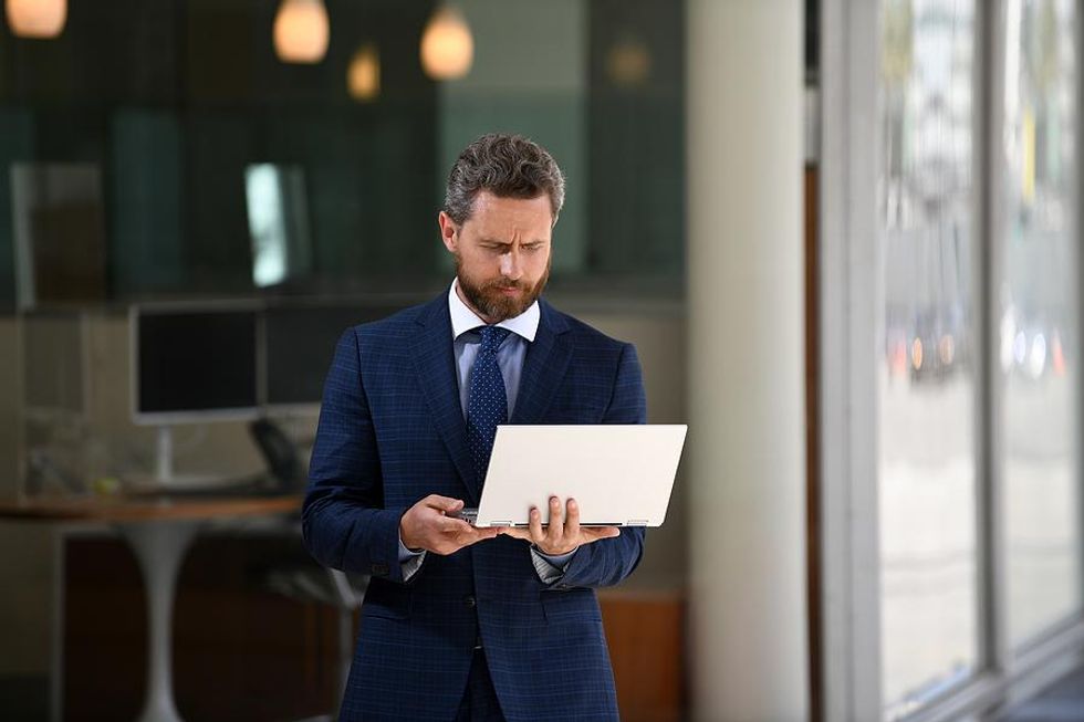 Man on laptop looks at his LinkedIn profile