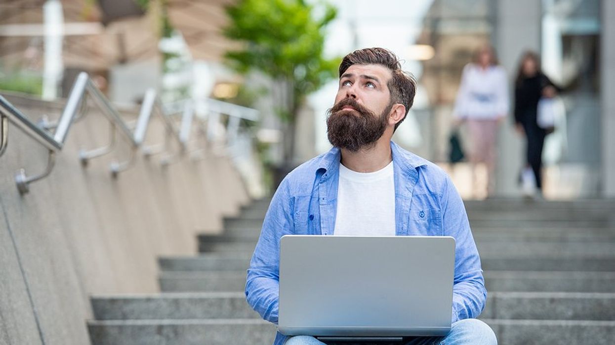 Man on laptop looks for a job while still employed