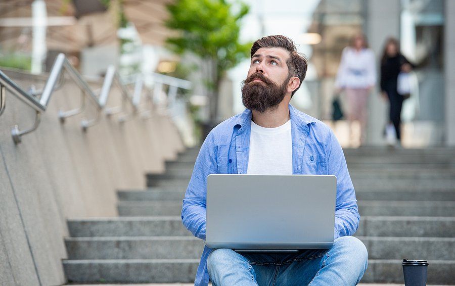 Man on laptop looks for a job while still employed
