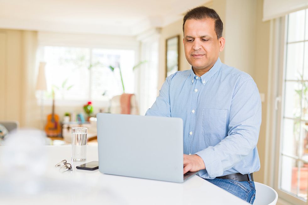 Man on laptop looks for opportunities to relaunch his career