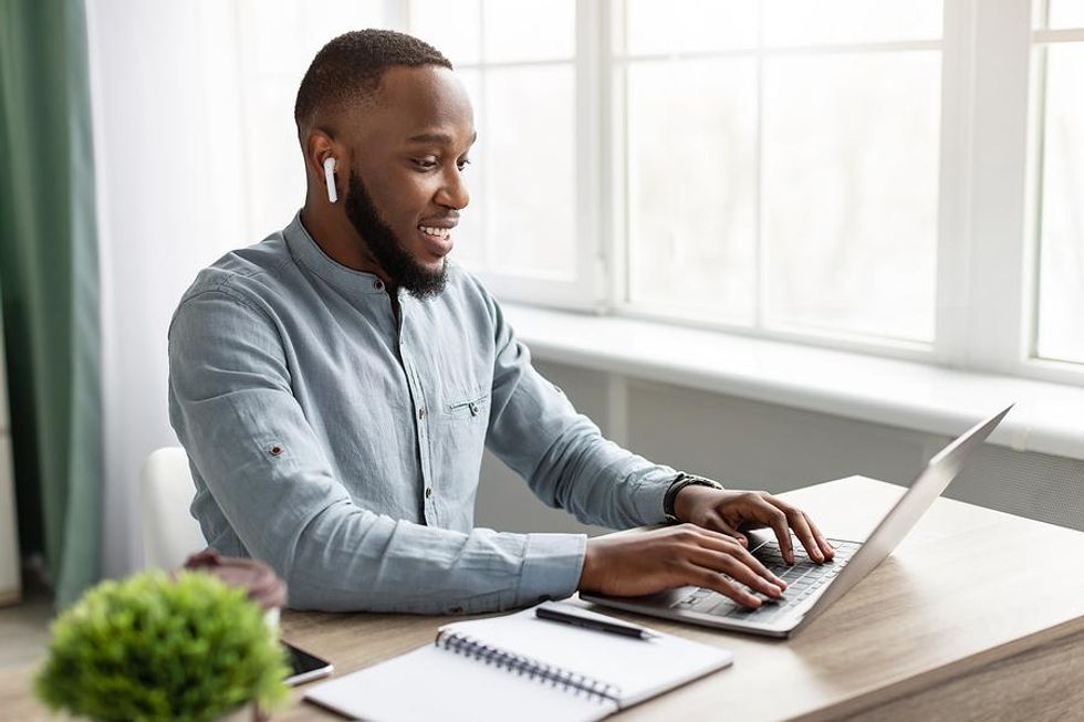 Man on laptop reaches out to connect with employees of the companies he wants to get hired at