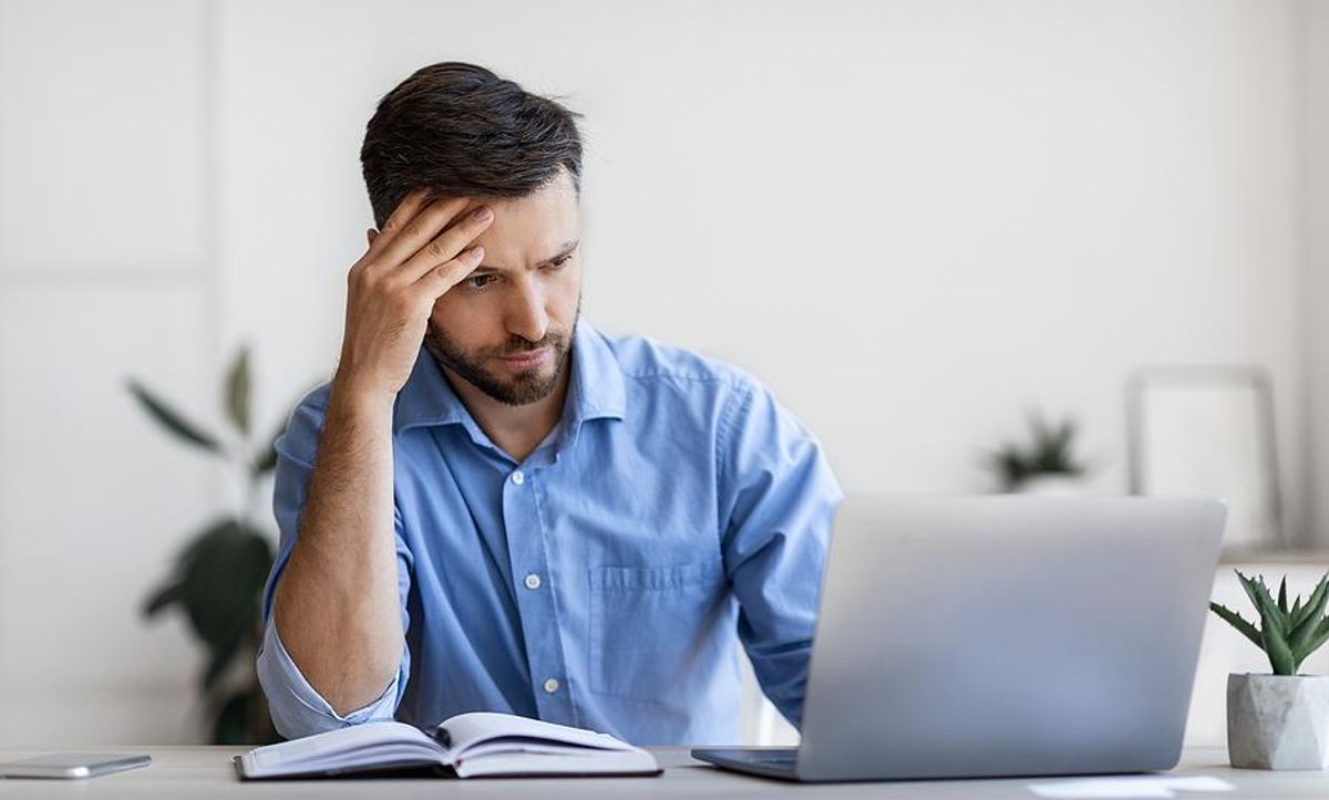 Man on laptop realizes he got ghosted by a LinkedIn connection