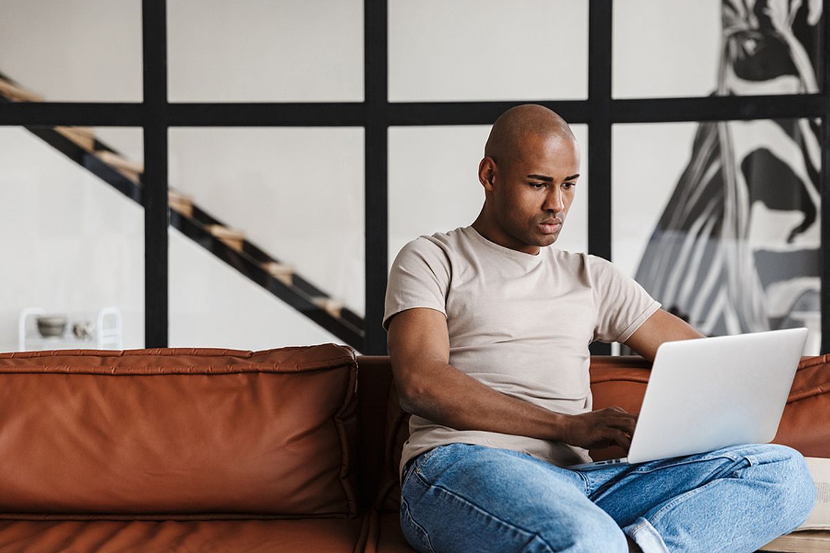 Man on laptop realizes the mistakes he made on his cover letter