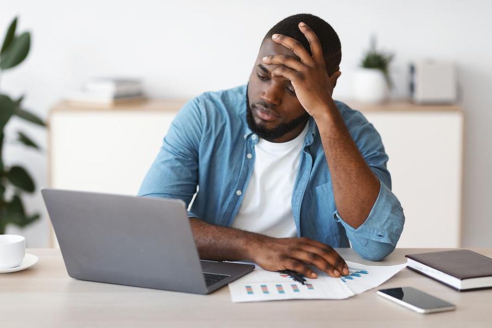 Man on laptop scared to find a new job