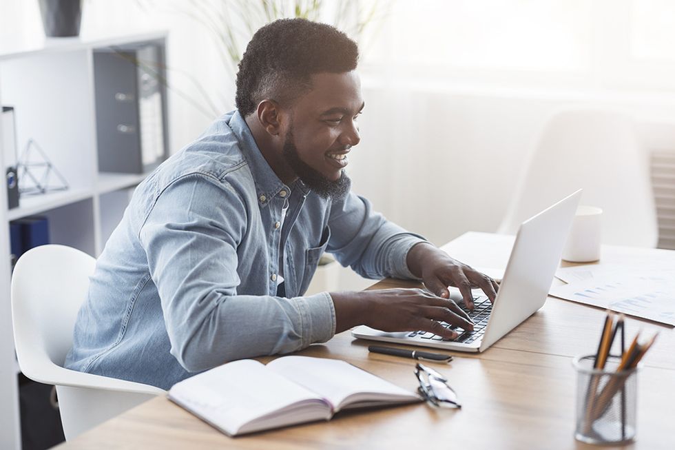 Man on laptop sends a follow-up email after a job interview