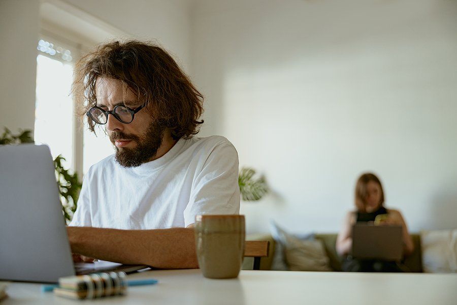 Man on laptop sends a follow-up email to an employer