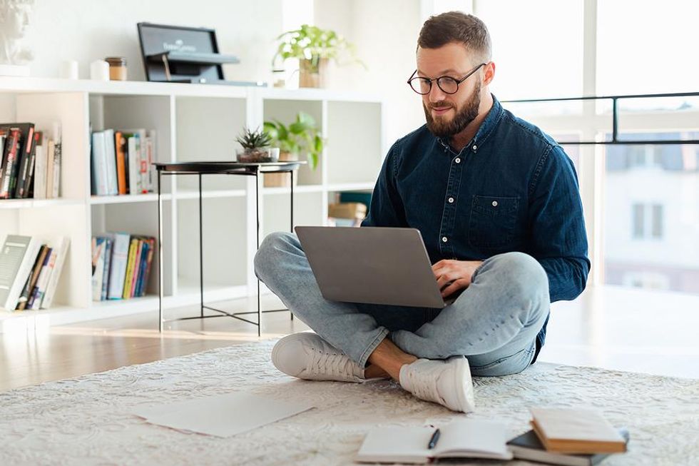 Man on laptop shares content with his professional network to help others