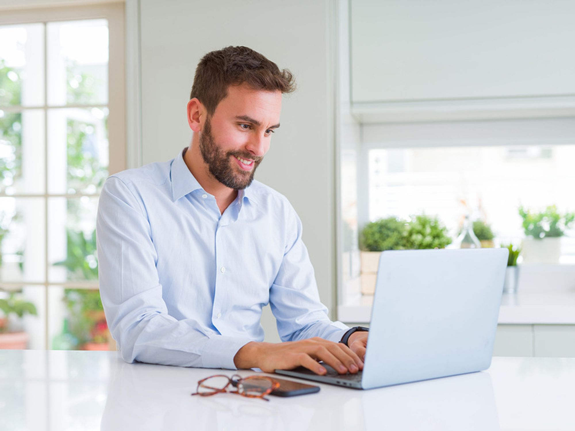 Man on laptop starting a conversation on LinkedIn with his new connection