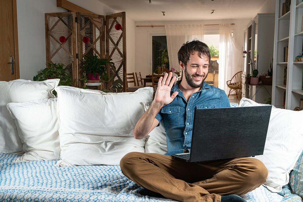 Man on laptop stays motivated in his job search by talking to inspiring people