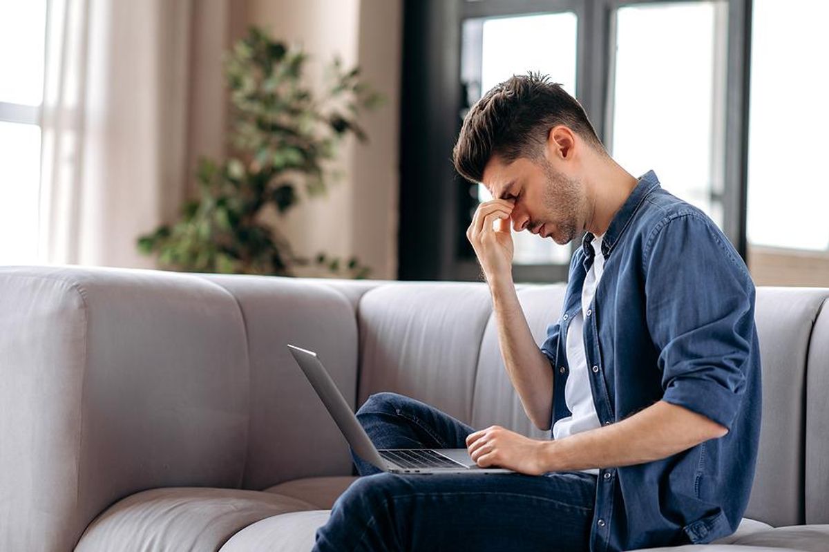 Man on laptop stressed about changing careers