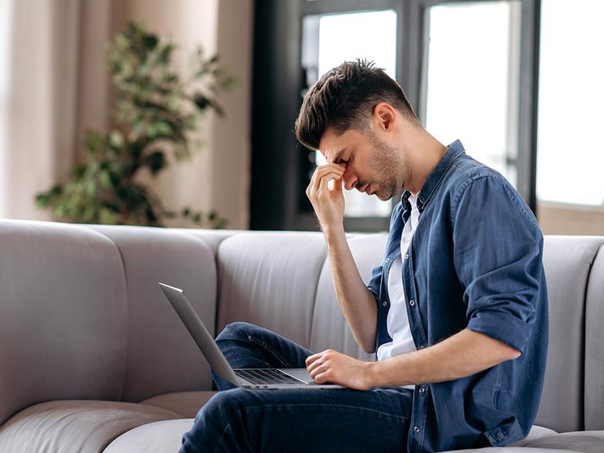 Man on laptop stressed about changing careers 