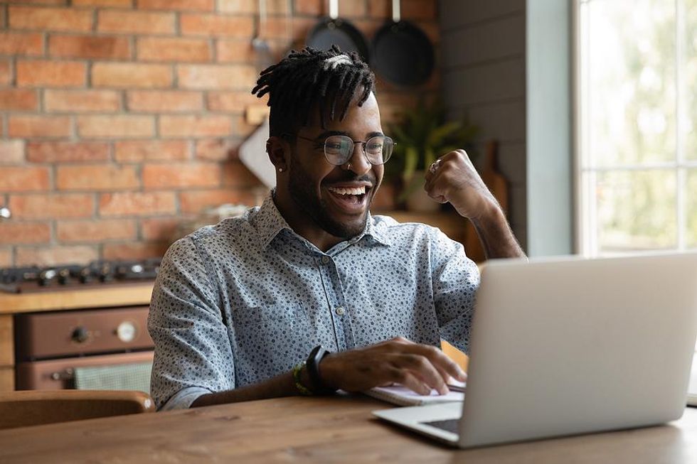 Man on laptop successfully gets his foot in the door at a company