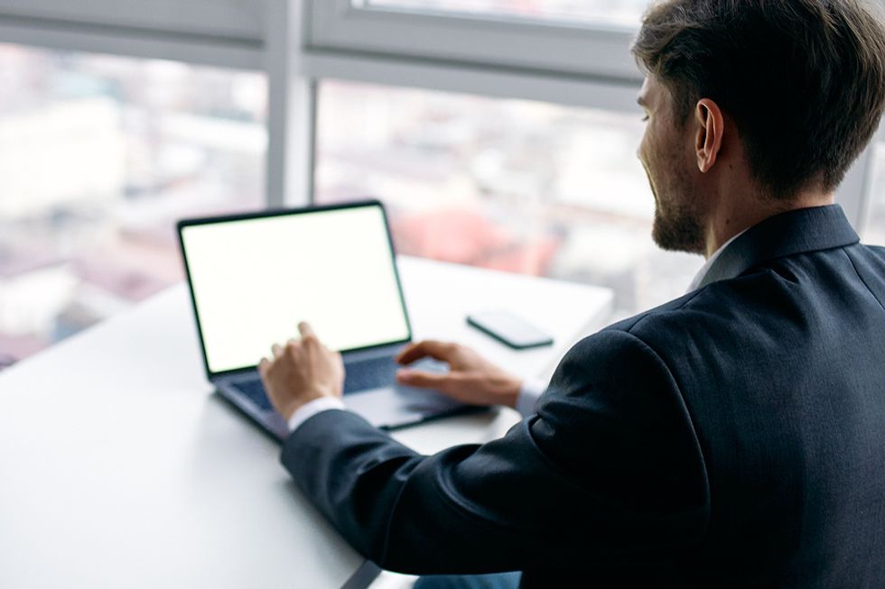 Man on laptop targets companies for an effective job search