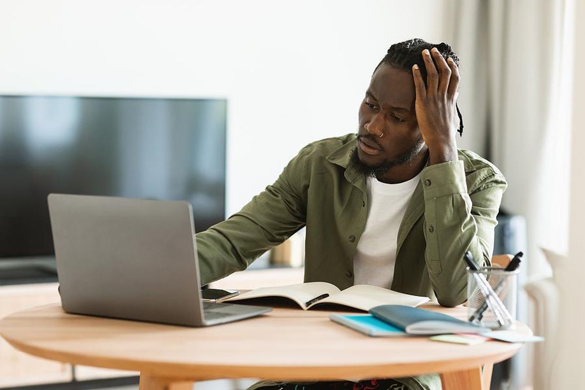 Man on laptop thinking about his career