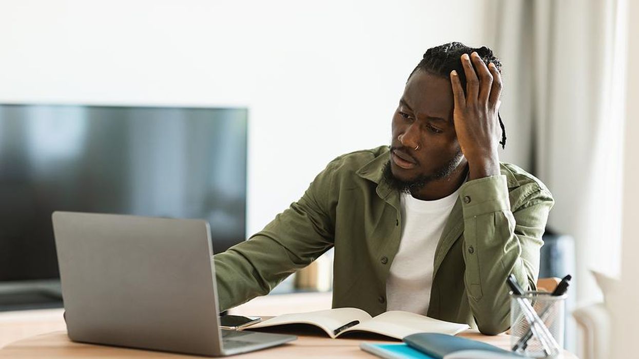 Man on laptop thinking about his career