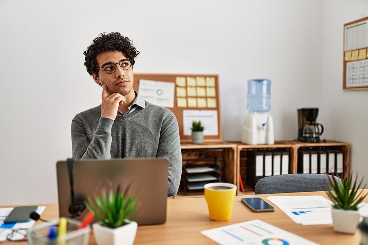 Man on laptop thinking about making a career change