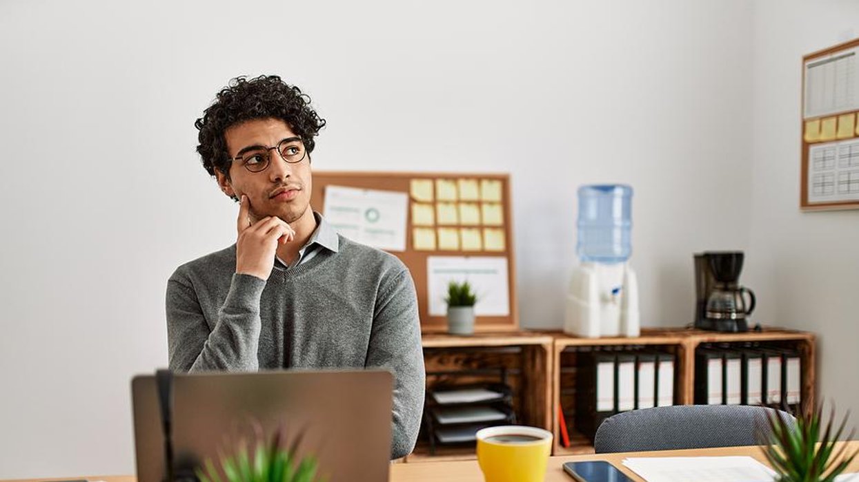 Man on laptop thinking about making a career change