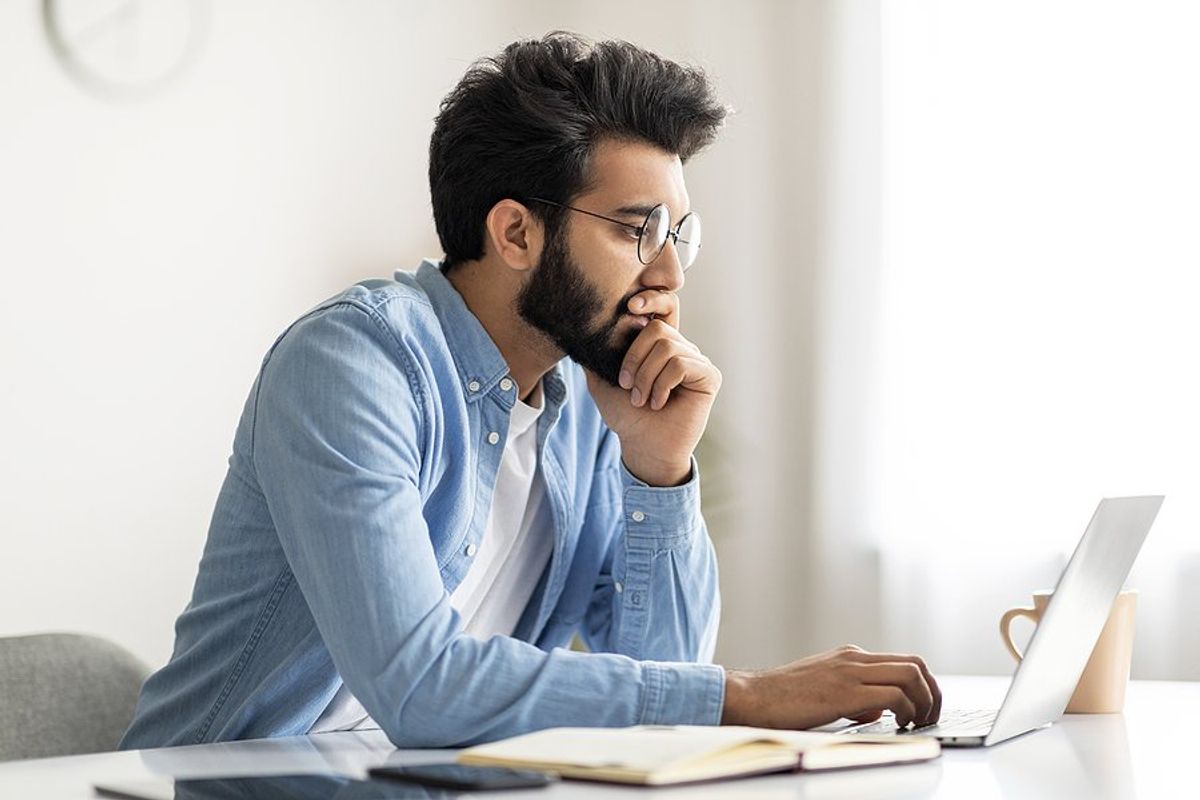 Man on laptop thinks he chose the wrong career path