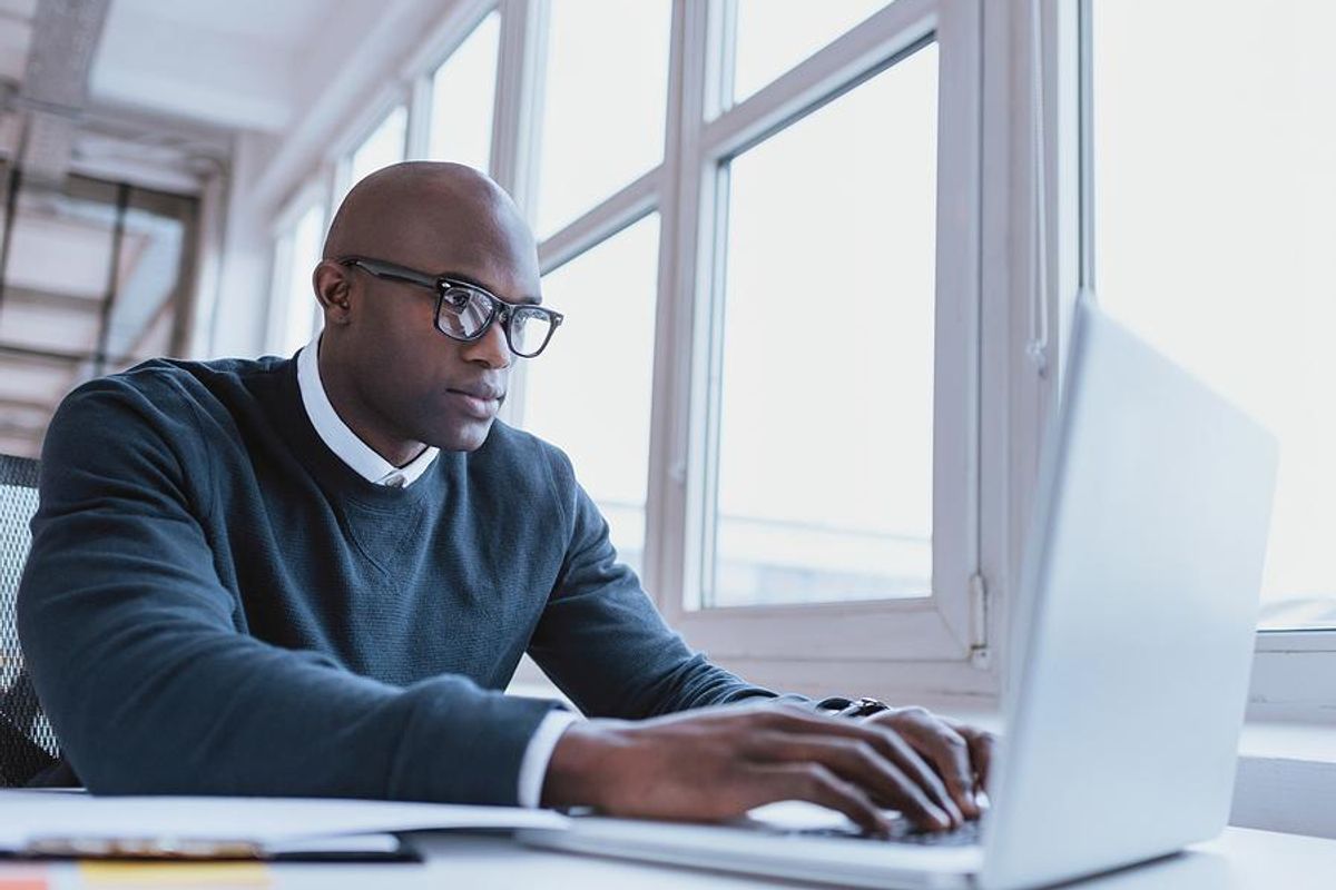 Man on laptop updates his LinkedIn profile