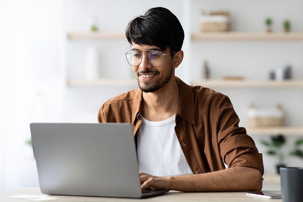 Man on laptop updates his LinkedIn profile