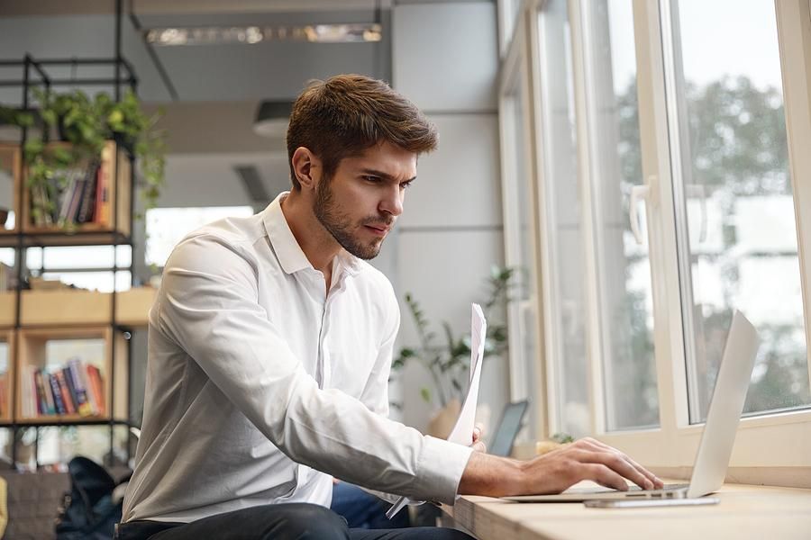 Man on laptop updates his resume