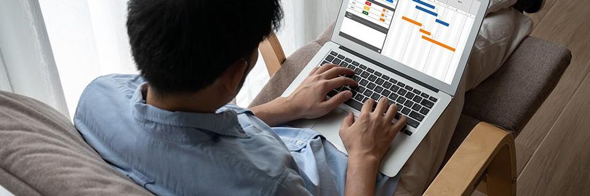 Man on laptop uses a project management platform