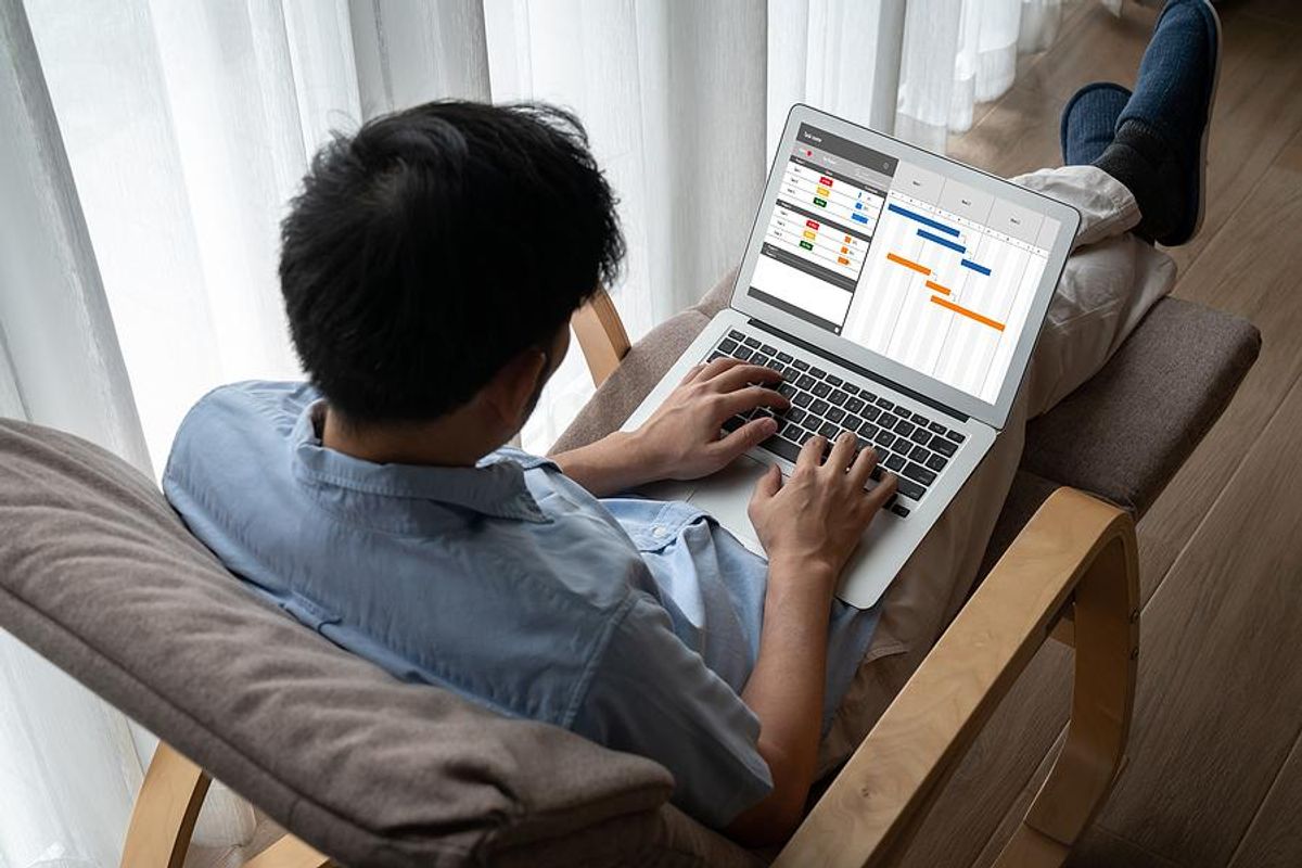 Man on laptop uses a project management platform