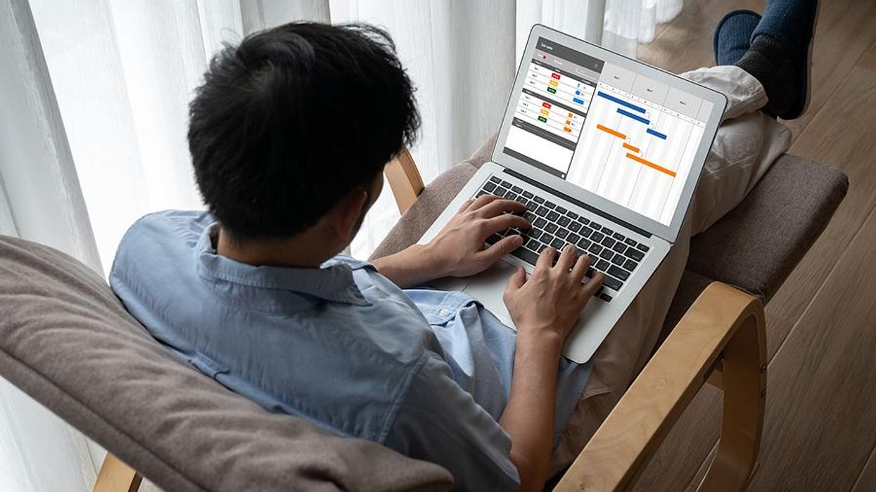 Man on laptop uses a project management platform