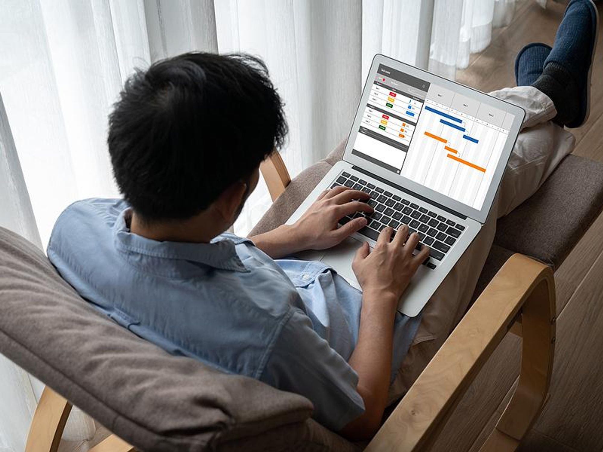 Man on laptop uses a project management platform