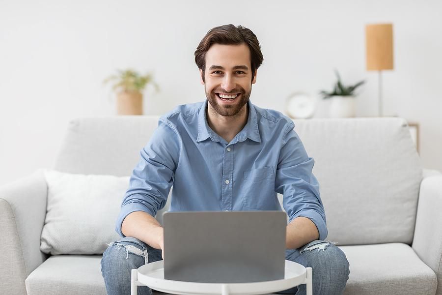 Man on laptop with a flexible work schedule works from home