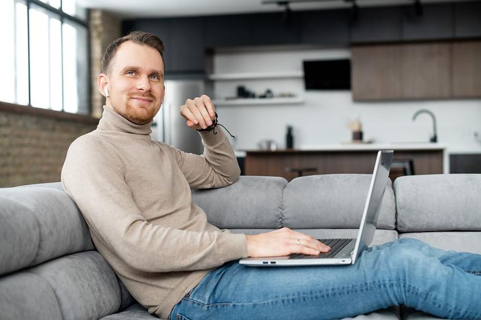 Man on laptop with a flexible work schedule works from home