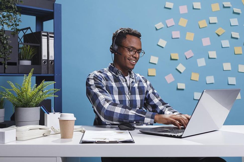 Man on laptop working customer service