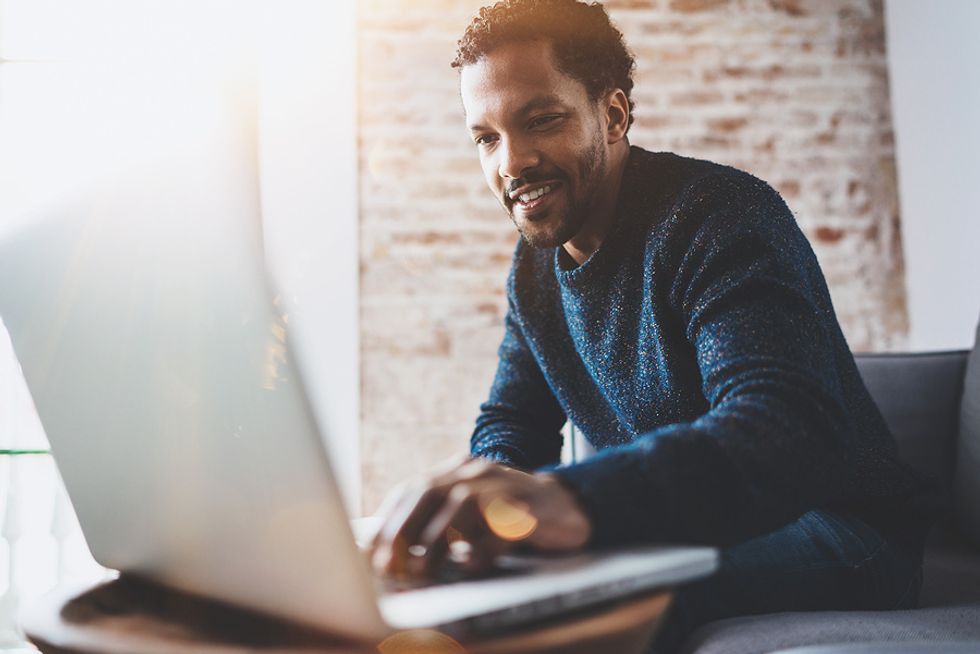 Man on laptop works remotely