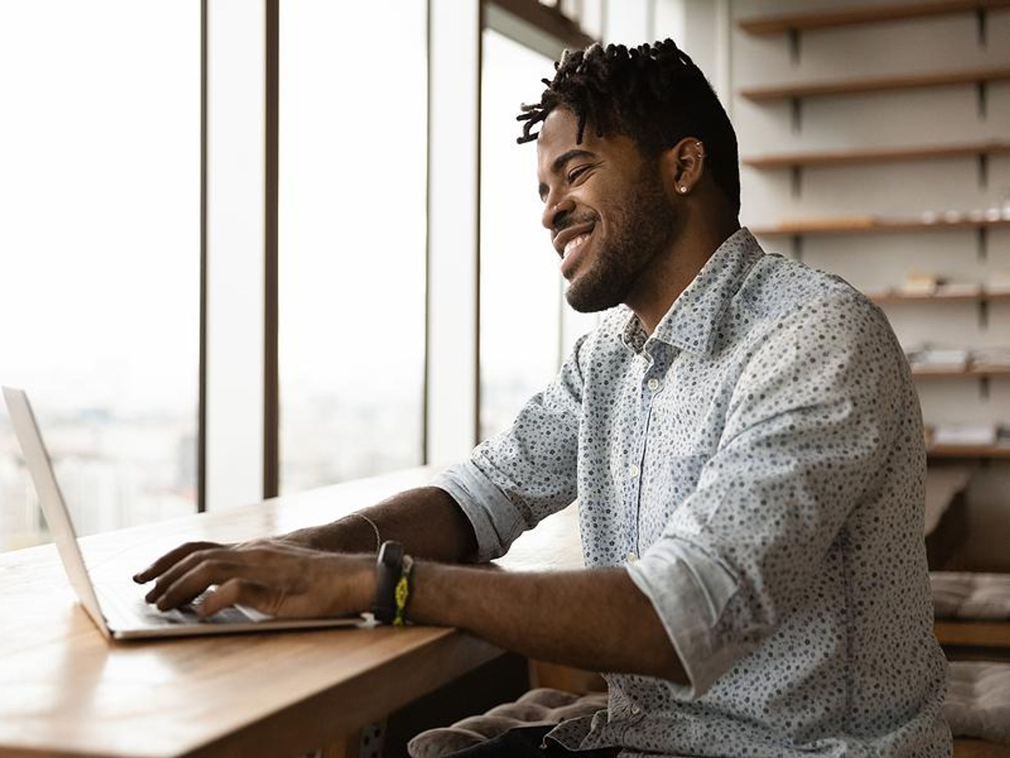 Man on laptop writes a cover letter that asks for the job interview