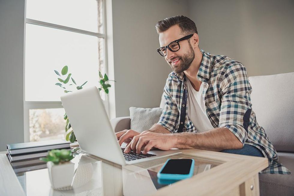 Man on laptop writes a thank-you note after a job interview