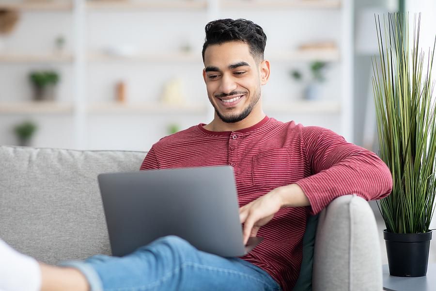 Man on laptop writes an introduction email to someone in his network