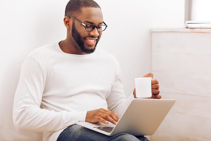 Man on laptop writes bullet points on his resume