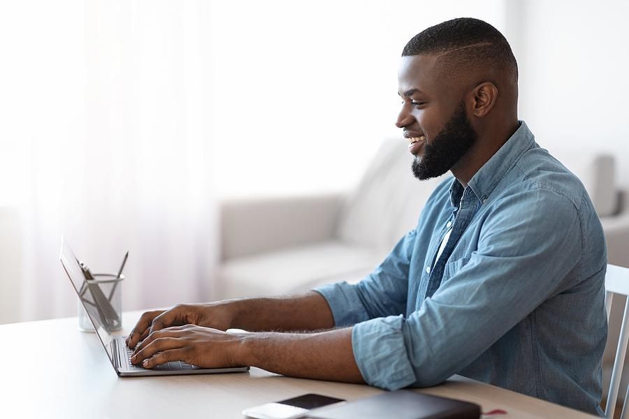 Man on laptop writes the most important part of his resume