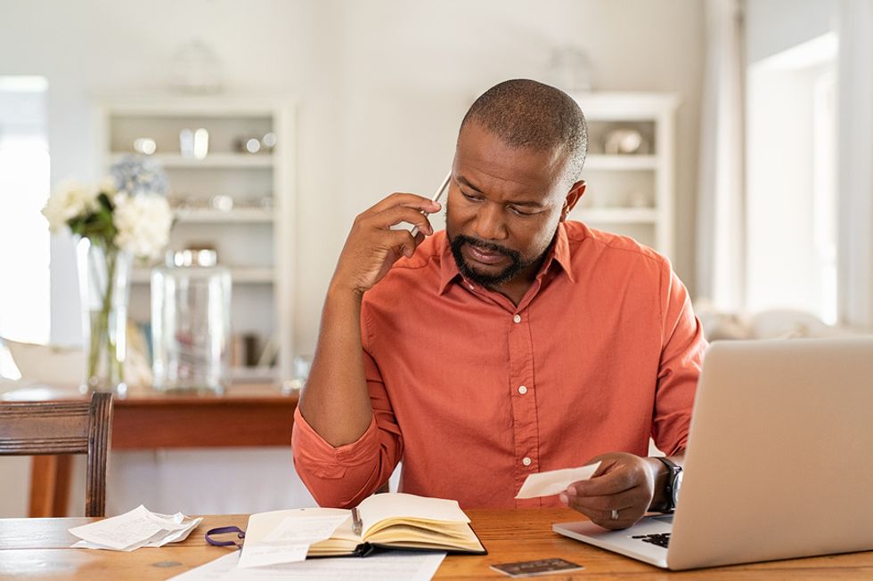 Man on phone reports a case of unemployment insurance fraud