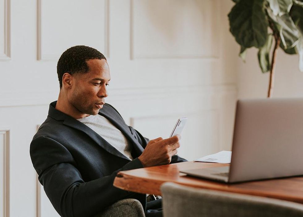 Man on phone thinks about his employment gap while applying for jobs