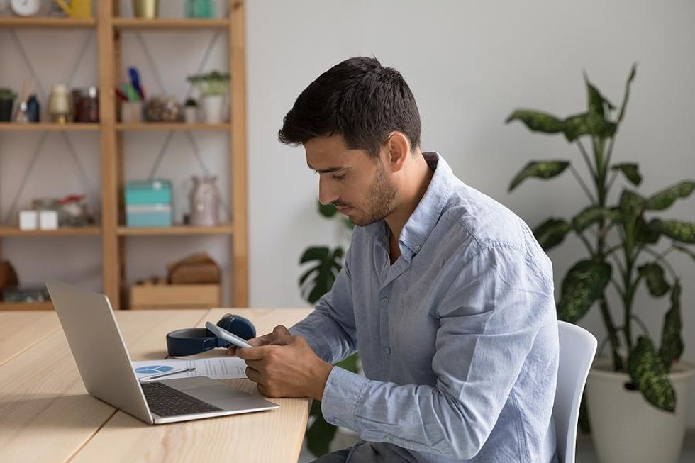 Man optimizes his LinkedIn profile on his phone